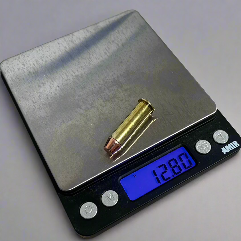 A digital caliper measuring the overall length of a single .38 Special brass dummy round.