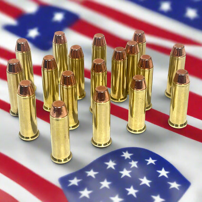 16 brass 38 Special dummy rounds with flat nose bullets, standing upright on an American flag background