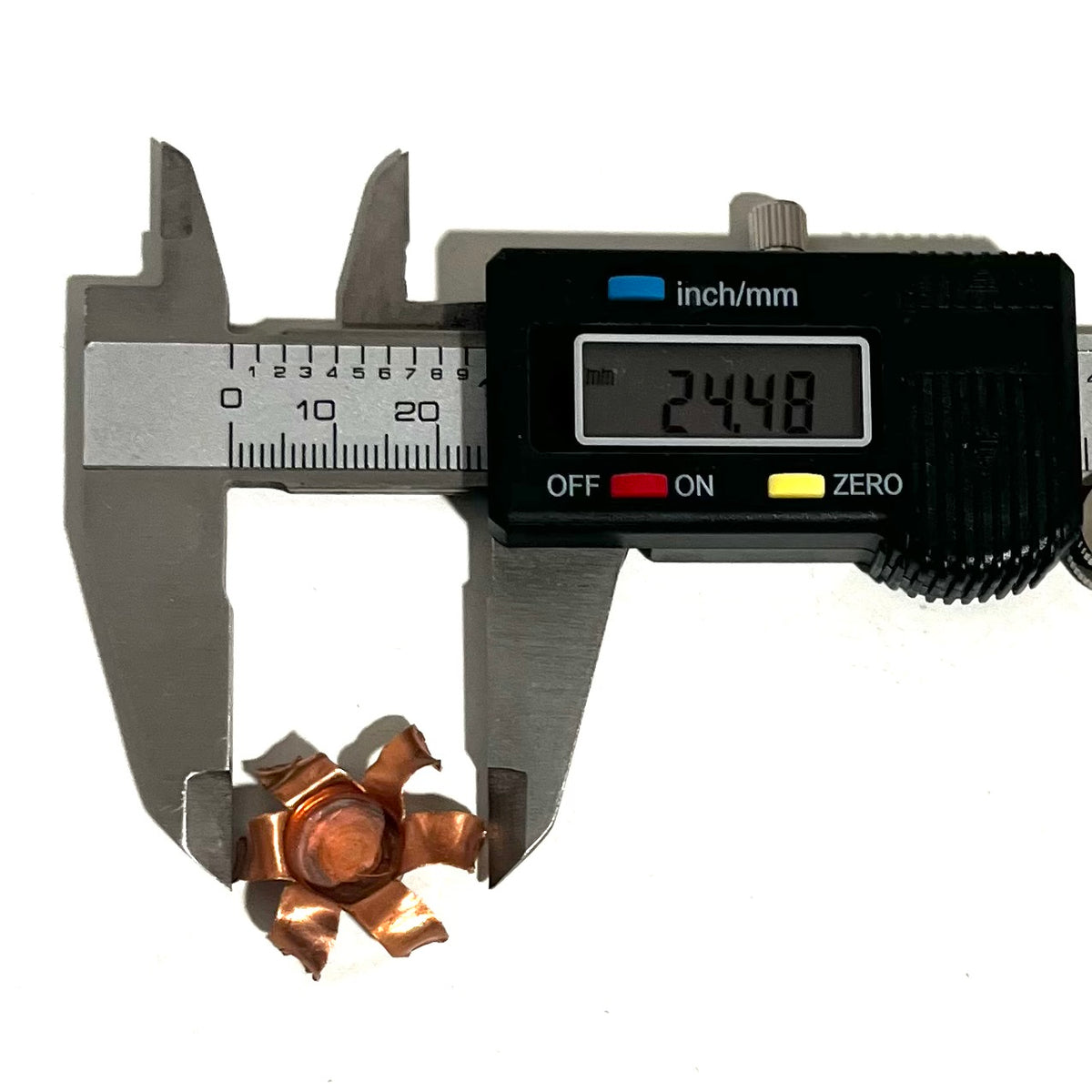 Digital caliper measuring an expanded copper bullet jacket blossom at 24.48 mm
