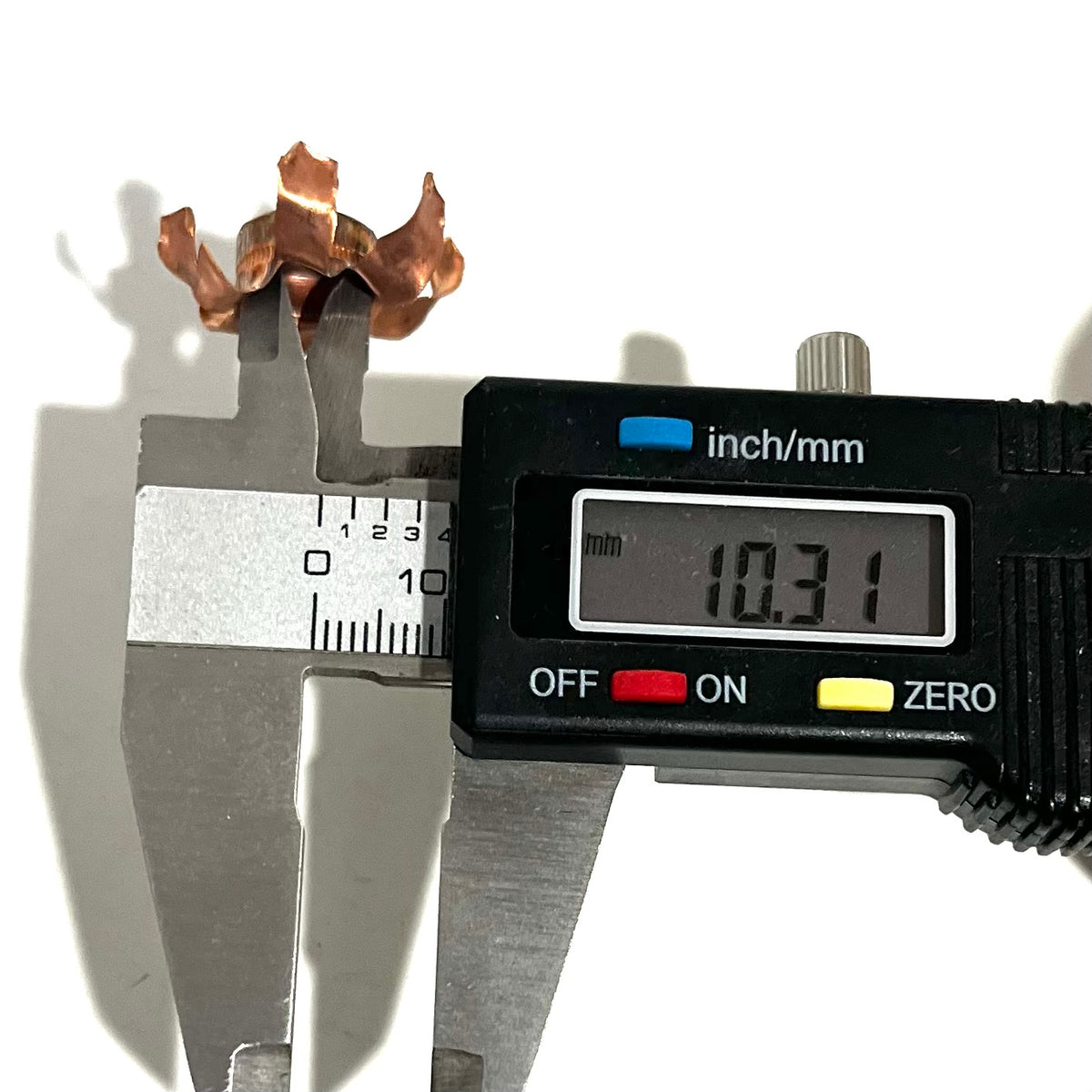 Digital caliper measuring an expanded copper bullet jacket blossom at 10.31 mm