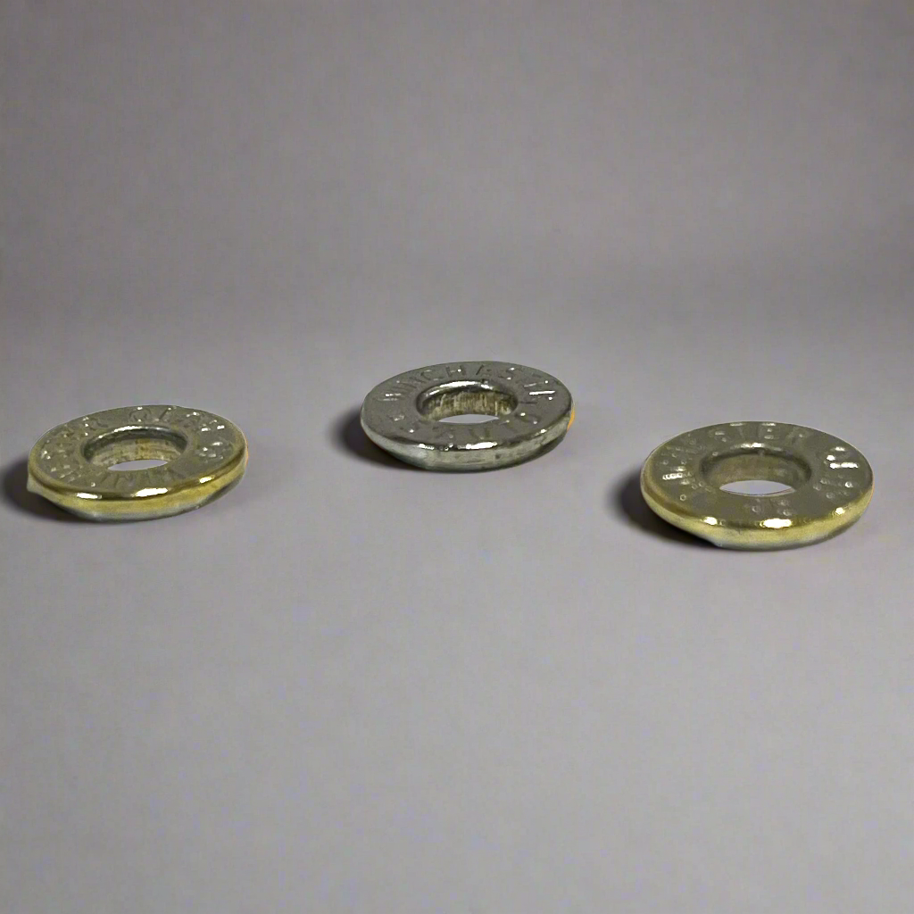 Three deprimed Winchester 45 Auto nickel cartridge slices arranged on a light grey reflective background.