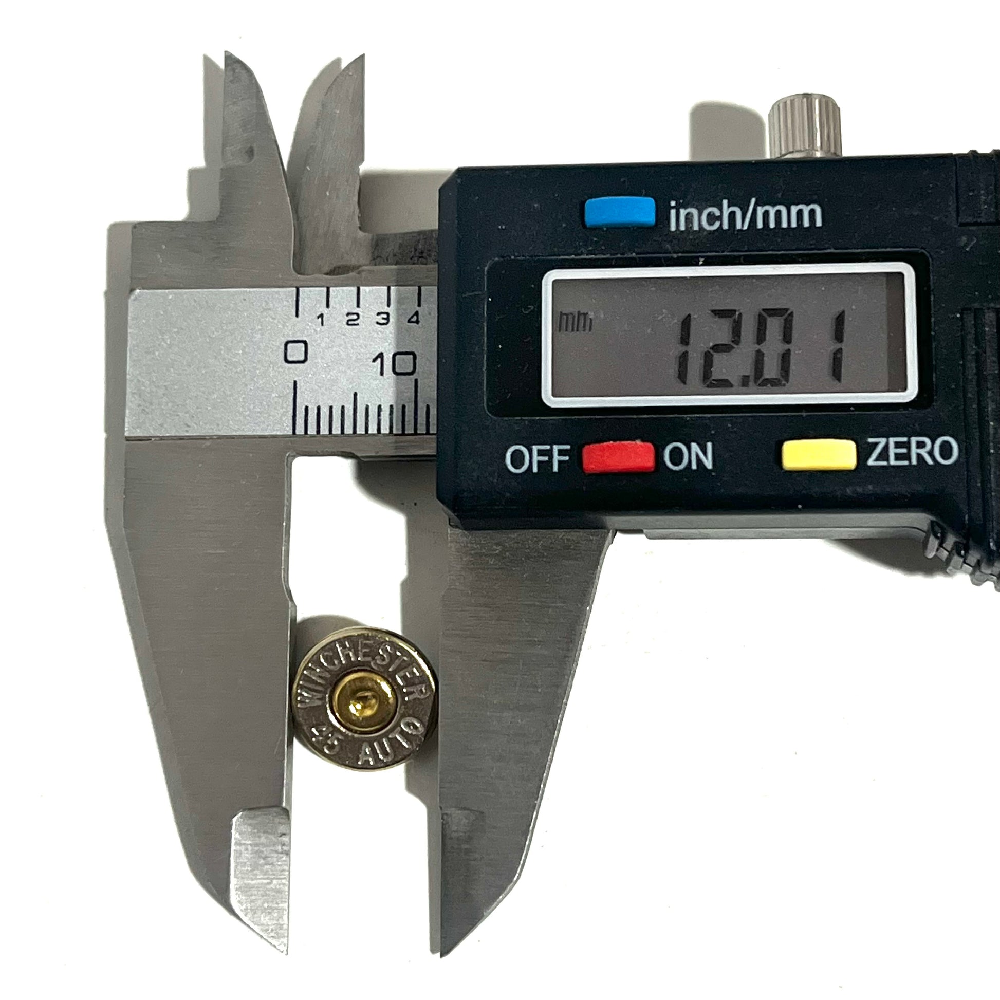 Digital caliper measuring a nickel 45 ACP bullet slice's diameter at 12.01 millimeters