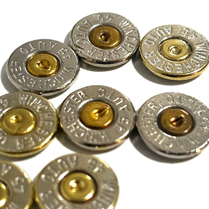Close-up of 8 nickel 45 ACP bullet slices with gold primers, engraved Winchester 45 Auto headstamps