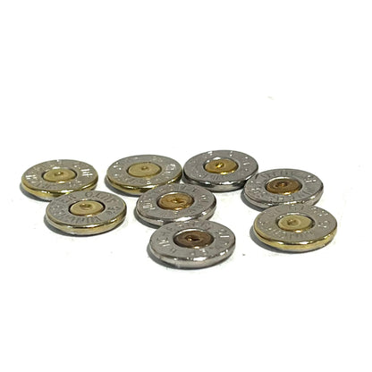 8 nickel 45 ACP bullet slices with gold and copper primers, engraved Winchester 45 Auto headstamps, arranged in a cluster