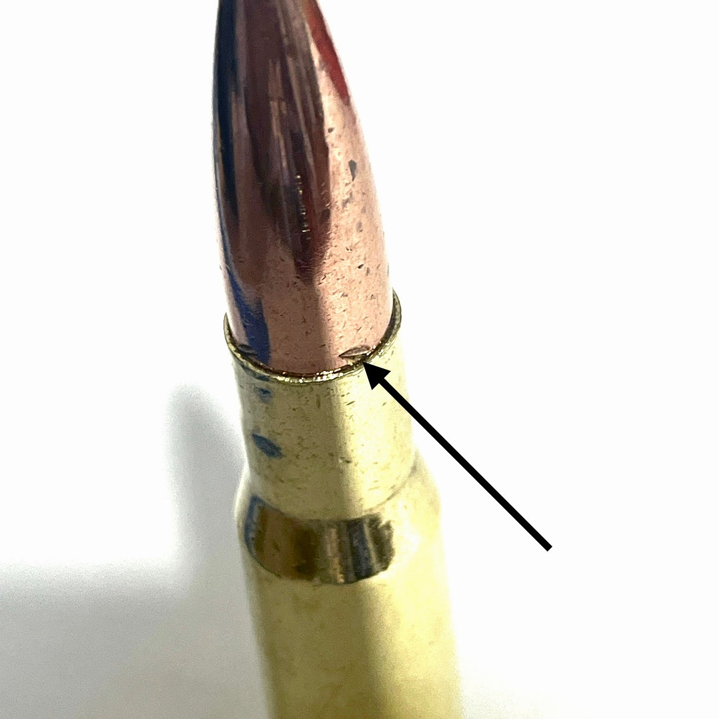 50 bmg projectile  closeup arrow pointing to pullmark