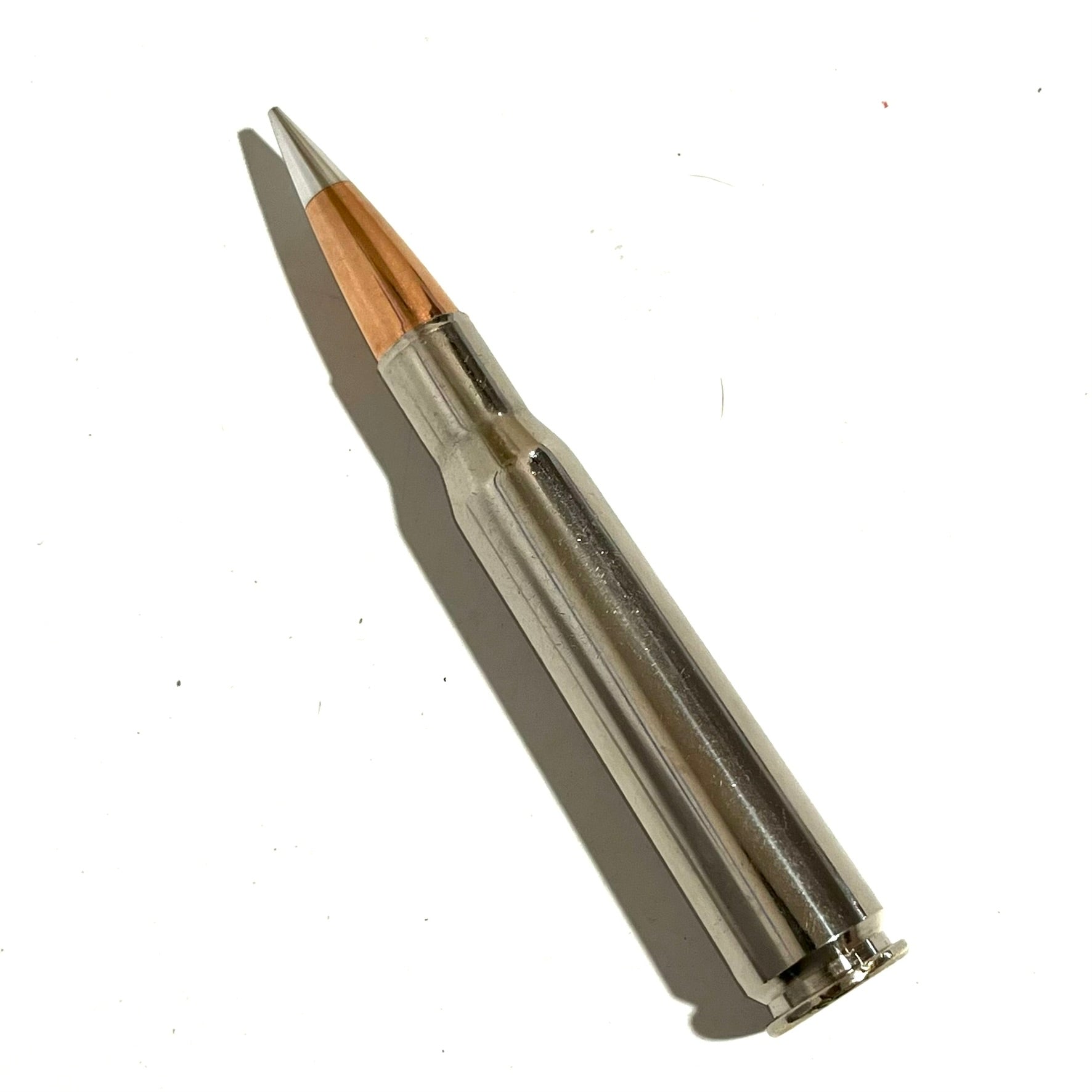 Polished 50 cal BMG dummy round with silver nickel casing and copper bullet tip by Empty Shotgun Shells.
