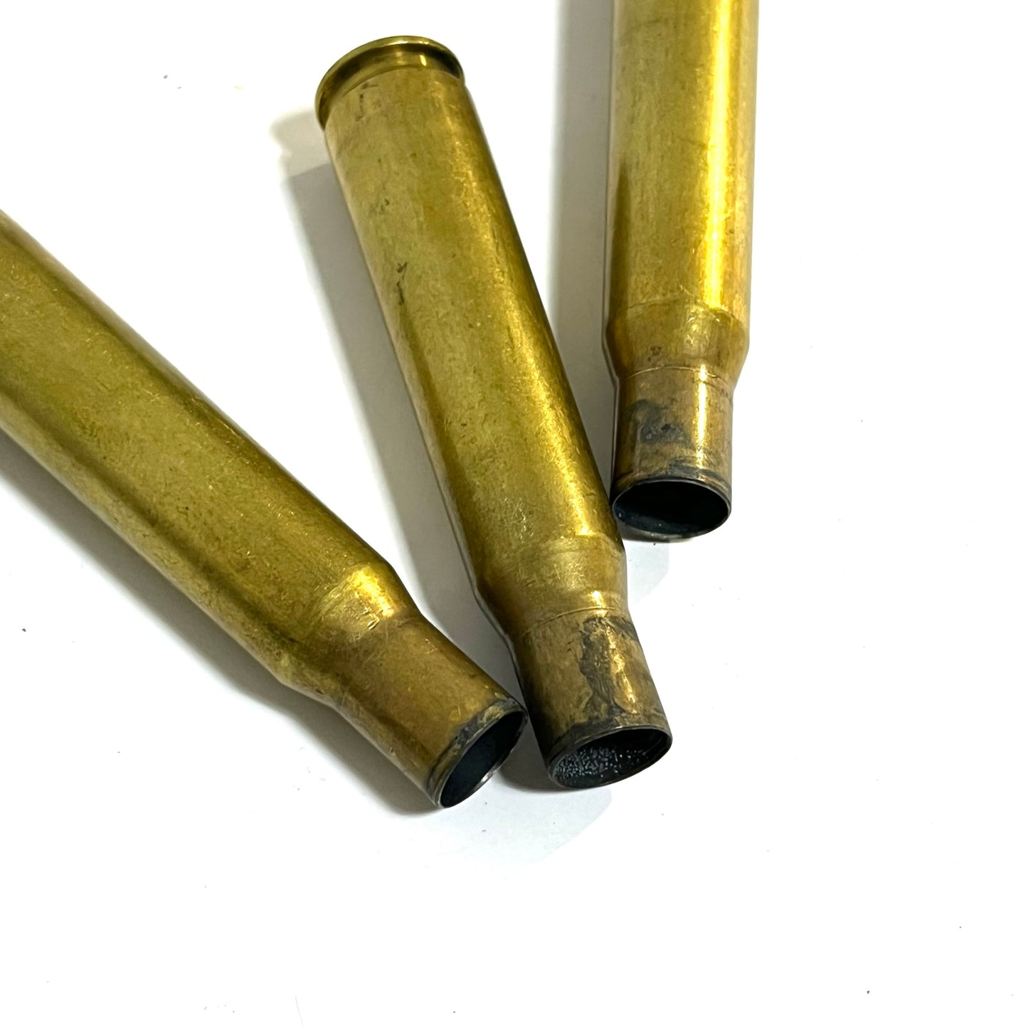50 Cal BMG once fired Brass casings on white background for film props 
