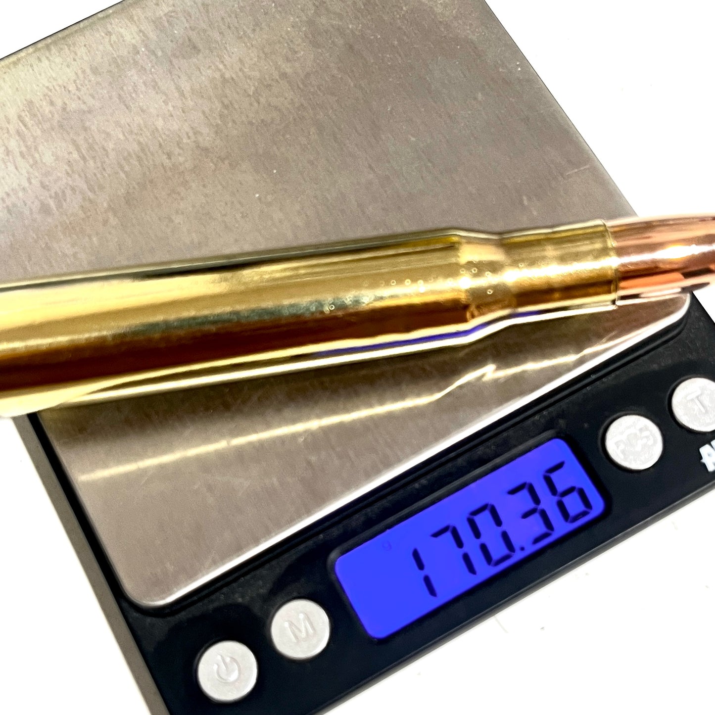 A 50 caliber paperweight display bullet resting on a digital scale showing a weight of 170.36 grams.