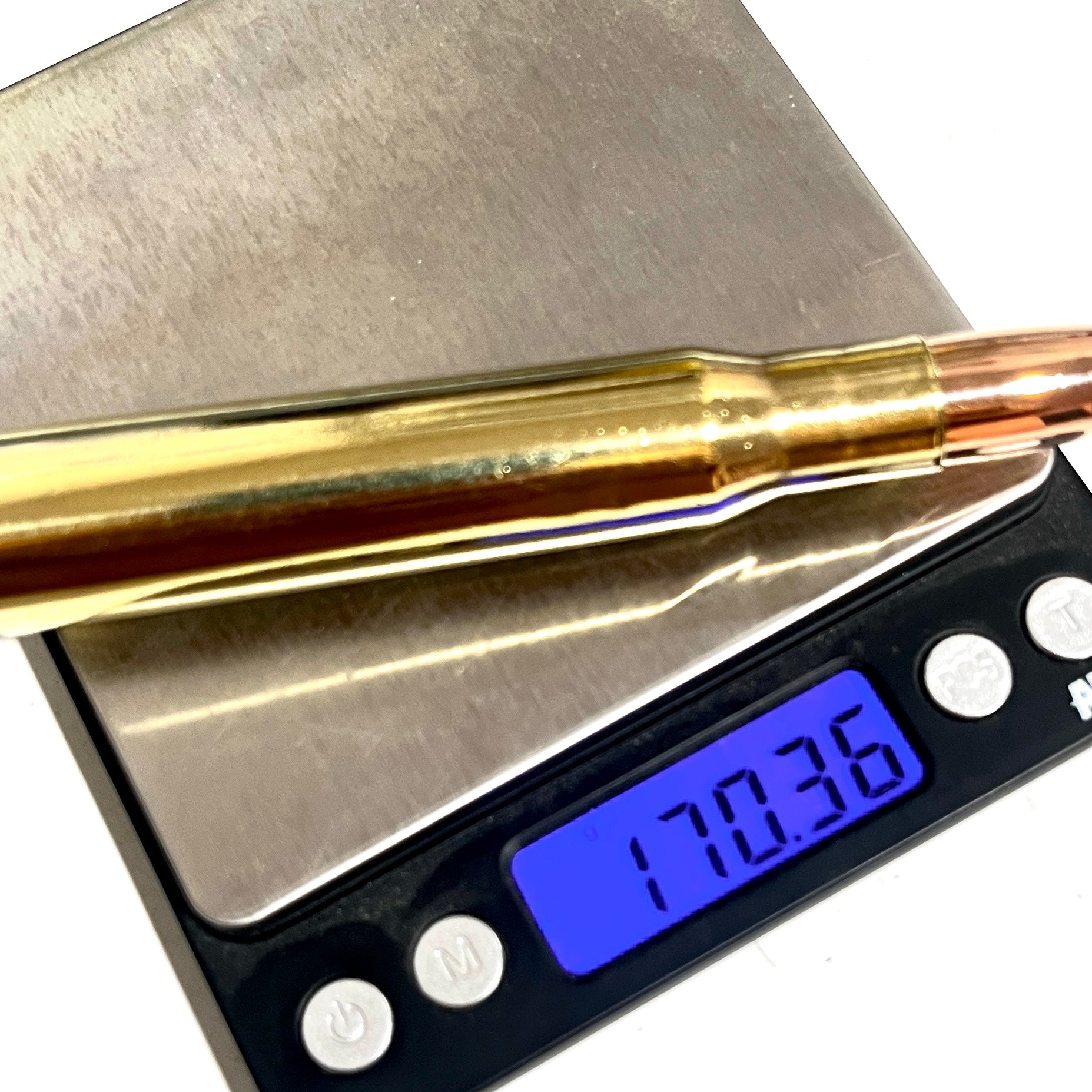 A 50 caliber paperweight display bullet resting on a digital scale showing a weight of 170.36 grams.