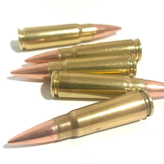 Five horizontal 7.62x39 dummy rounds with copper bullets and authentic once-fired brass casings on white background.
