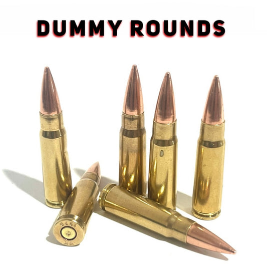 Six 7.62x39 dummy rounds by Empty Shotgun Shells, four standing, two laying, spent primer dimples, DUMMY ROUNDS text.
