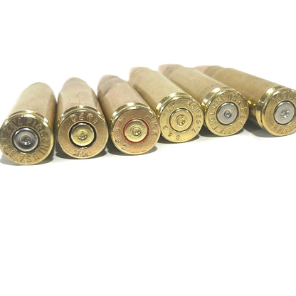 Close-up of six 7.62x39 dummy round headstamps showing spent dimpled primers and authentic Fiocchi brass markings.
