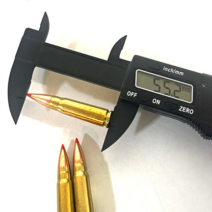 Digital caliper measuring a brass 7.62x39 dummy round's length at 55.2 millimeters, with two more rounds beside it