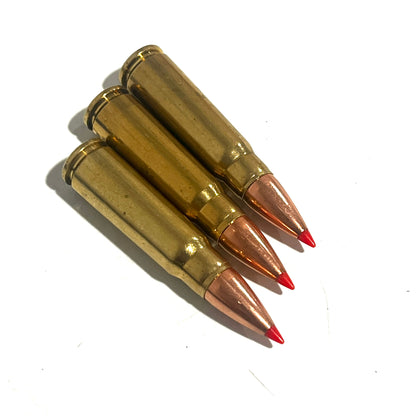 3 brass 7.62x39 dummy rounds with red-tipped bullets standing upright showing headstamps, viewed from the base