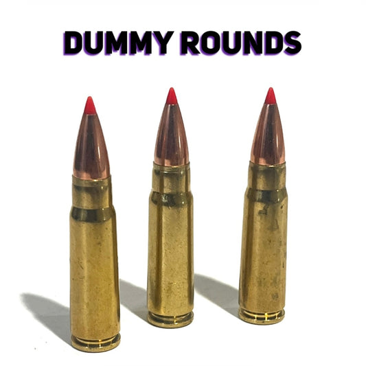 3 brass 7.62x39 dummy rounds with red-tipped bullets, standing upright under a Dummy Rounds text banner