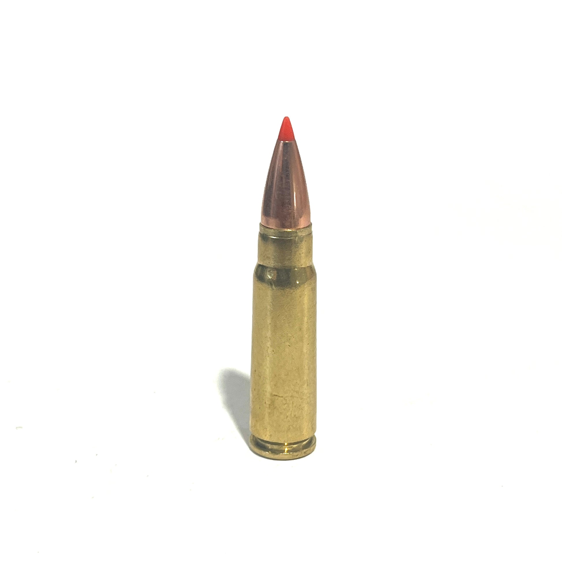 Single brass 7.62x39 dummy round with a red-tipped bullet, standing upright on a white background