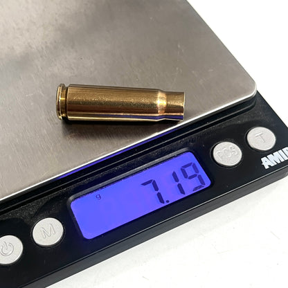 Spent brass shell resting on a digital scale, with the display showing a weight of 7.19 grams.