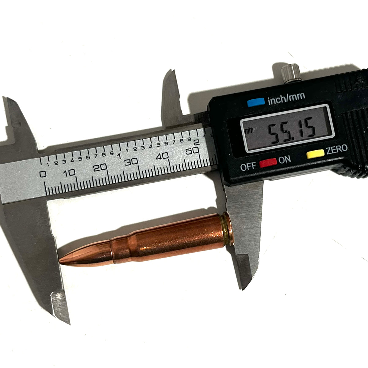 Digital caliper measuring a copper 7.62x39 dummy round's length at 55.15 millimeters