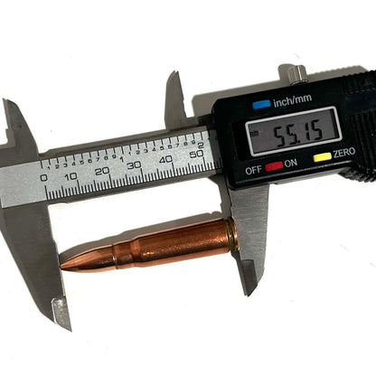 Digital caliper measuring a copper 7.62x39 dummy round's length at 55.15 millimeters