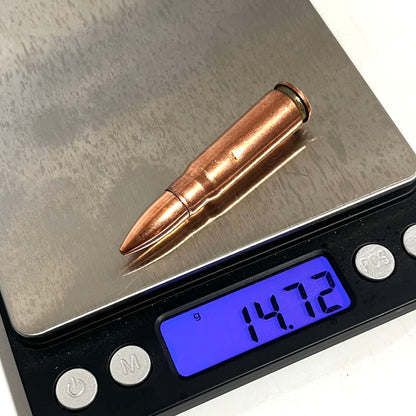 Copper 7.62x39 dummy round on a digital scale reading 14.72 grams