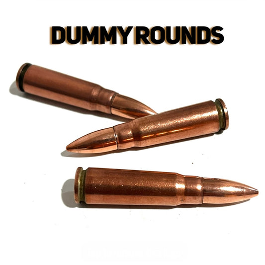 3 copper 7.62x39 dummy rounds with pointed bullet tips, arranged on a white background with Dummy Rounds text overlay