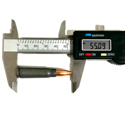 A 7.62x39 dummy round measured with a digital caliper reading 55.09 mm.