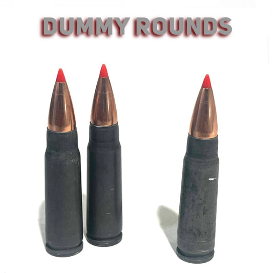 3 steel 7.62x39 dummy rounds with red-tipped bullets, standing upright under a Dummy Rounds text banner