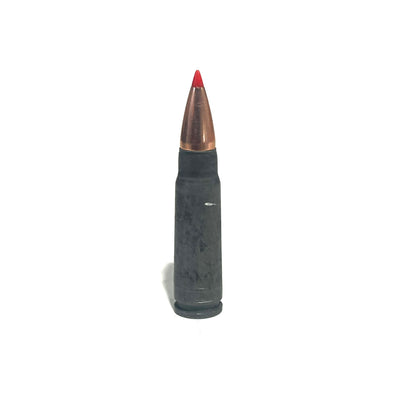 Single steel 7.62x39 dummy round with a red-tipped bullet, standing upright on a white background