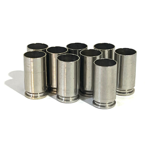 Nine deprimed 9mm nickel shells standing upright, showing open case mouths and base rims