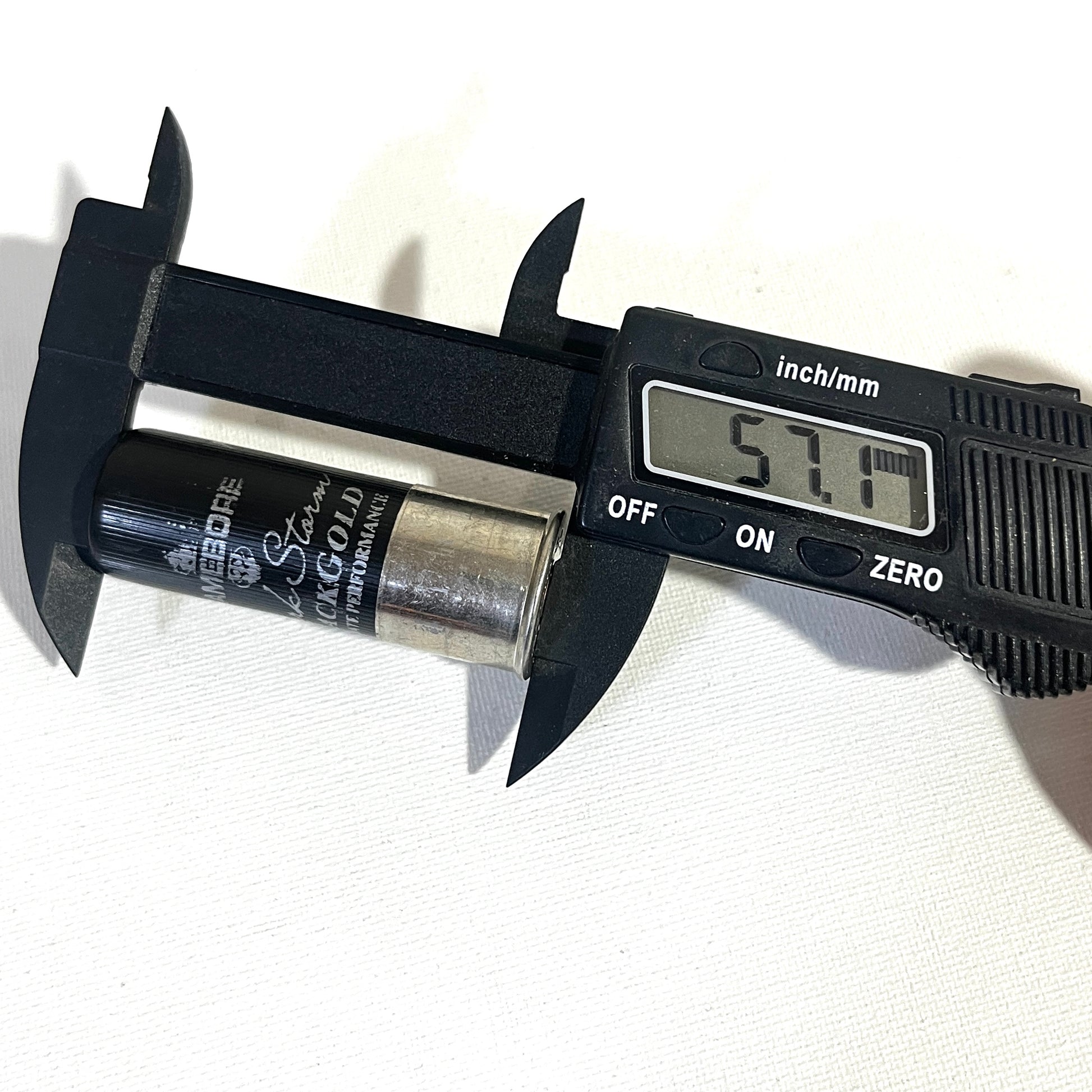 Gamebore Black Gold fake shotgun shell measured with calipers at 57.1 mm in length