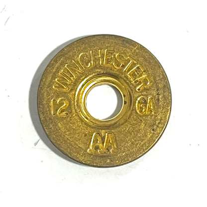 A single gold Winchester AA shell slice shows a clean headstamp reading 12 GA and AA on its face.