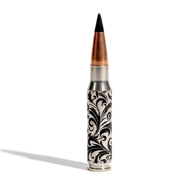 Baroque engraved inert bullet casing with a distinctive black projectile tip, showing precise craftsmanship