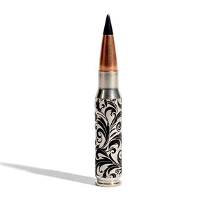 Baroque engraved inert bullet casing with a distinctive black projectile tip, showing precise craftsmanship