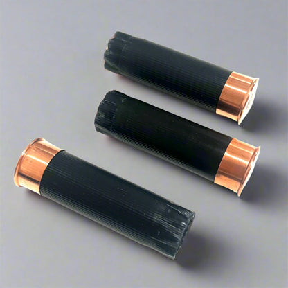 3 black shotgun shell hulls with copper bases viewed from below showing Remington Peters 12 gauge headstamps