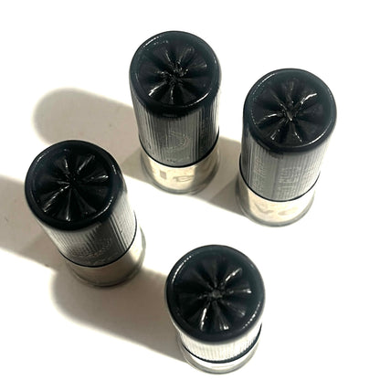 Four black 12-gauge shotshells viewed from above, showing star-crimped tops and silver metal bases.