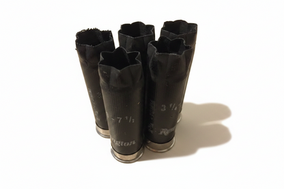 Five black Remington 12 gauge shotgun shells standing upright showing 6 star crimped tops and printed hull text.