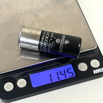 Black Gamebore fake shotshell on a digital scale reading 11.45 grams