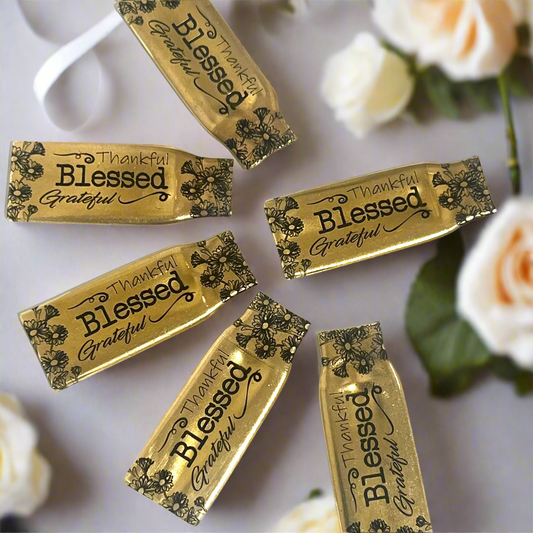Six flattened .308 brass casings engraved with flowers and the words Thankful, Blessed and Grateful