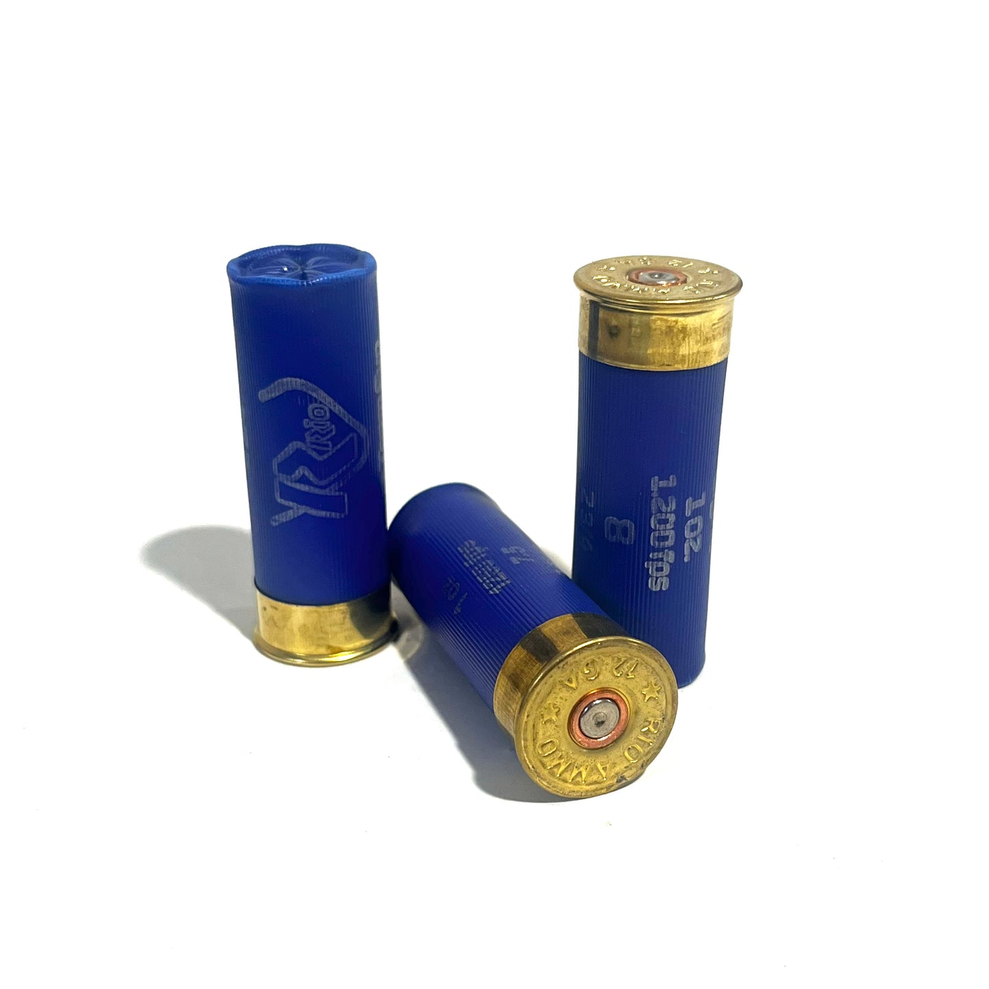 Three blue 12 gauge dummy shotgun shells with gold bases standing and lying on white background