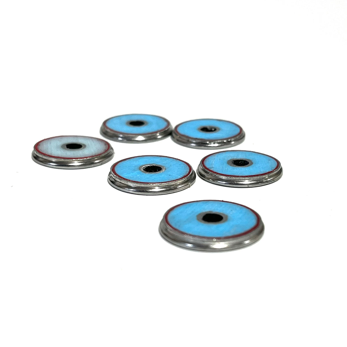 Six shotgun shell slices shown from the back, revealing turquoise-blue undersides with silver rims.