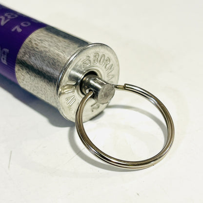 Close-up of the Bornaghi headstamp on a used purple casing, with a stainless swivel pin and split ring set in the base