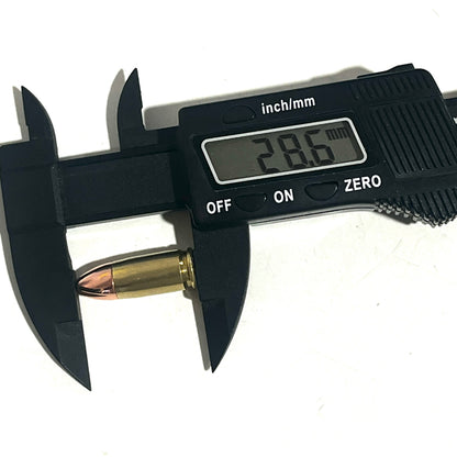 Black digital caliper measuring the total length of a brass 9mm dummy round, showing a display reading of 28.6 mm.