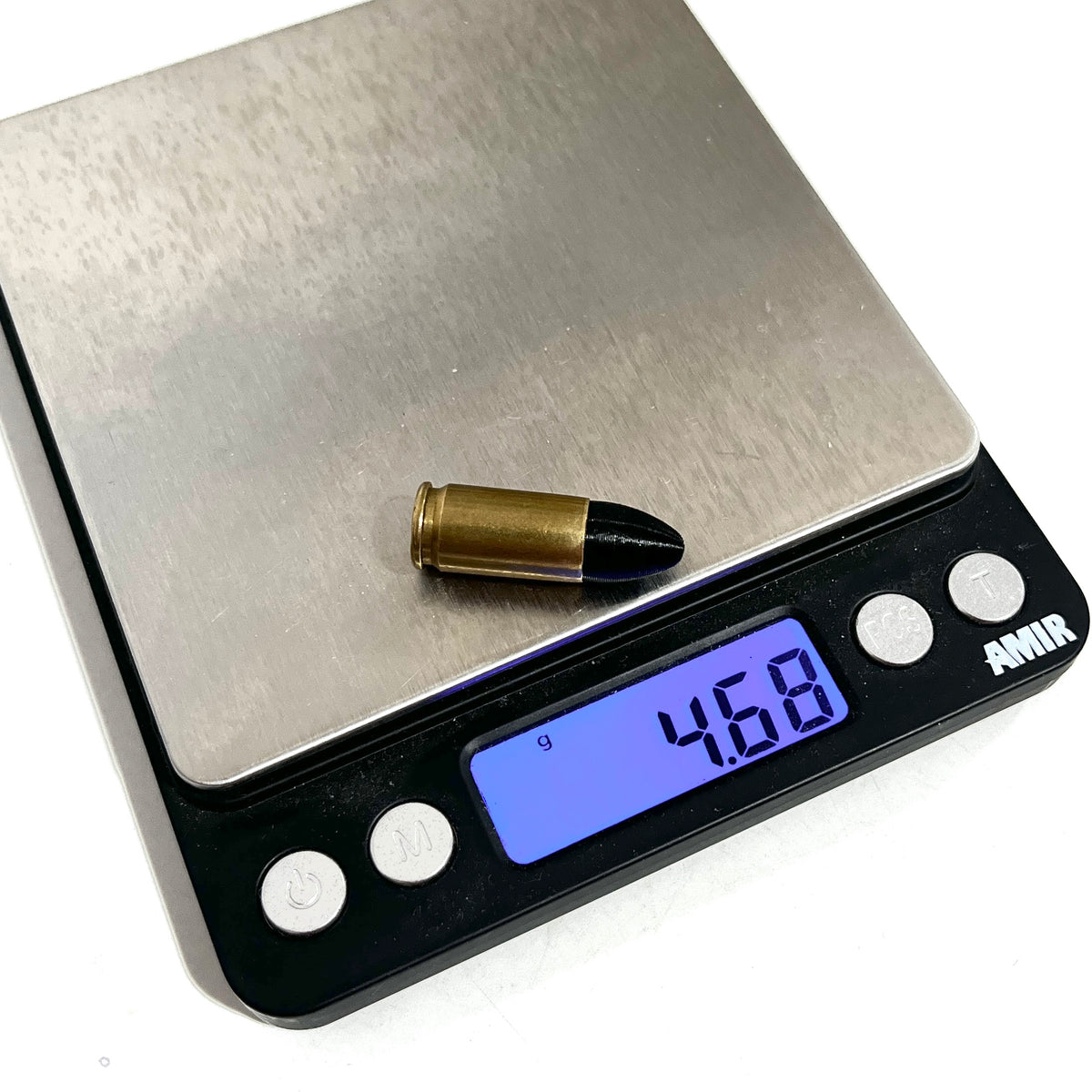 Fake 9mm Luger dummy round with black painted tip on a digital gram scale reading 4.68 grams