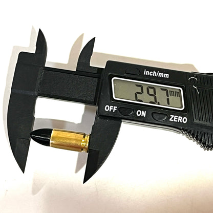 Digital caliper measuring the length of a fake 9mm Luger dummy round with black tip at 29.7mm