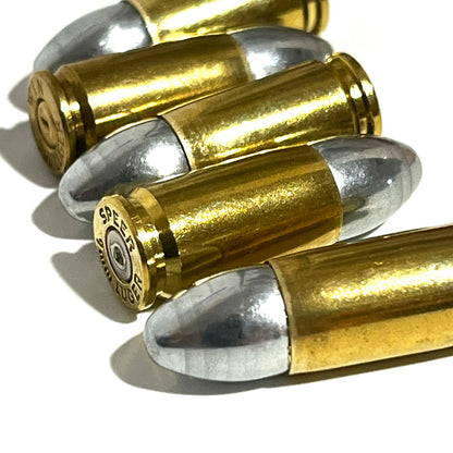 Several brass 9mm Luger hulls fanned out, with a Speer headstamp visible on one base.