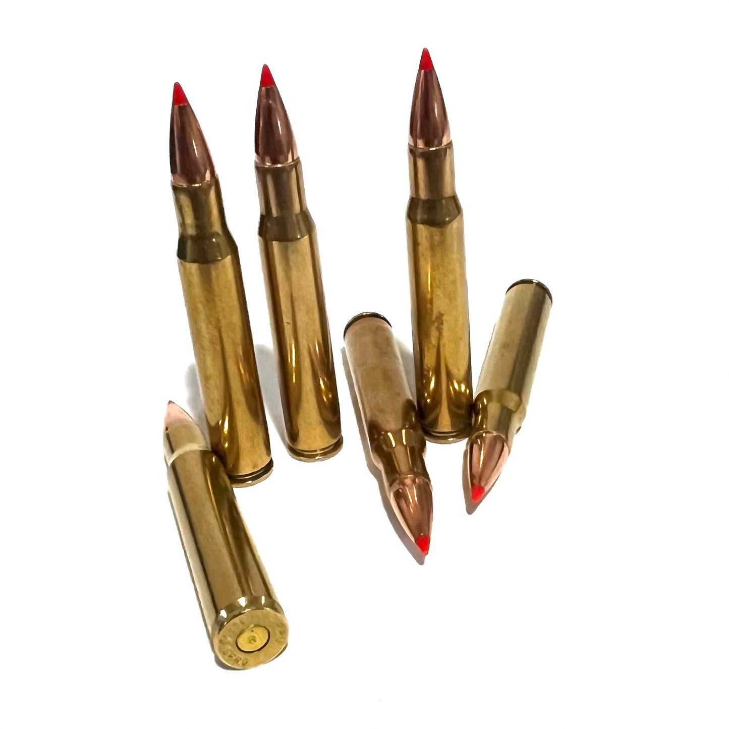Six brass red tip cartridges arranged together, three standing upright and three lying at angles.