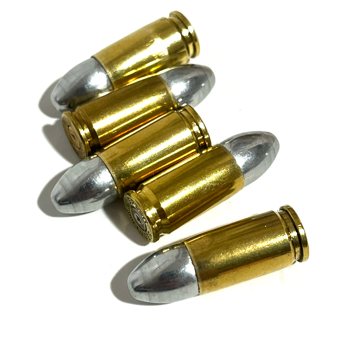 Five brass 9mm dummy cartridges cascading diagonally, with one base and headstamp visible.