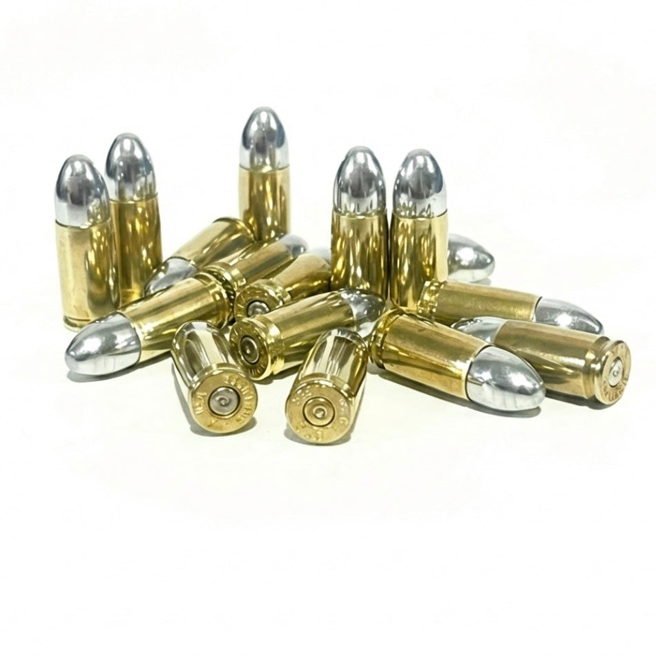 A jumbled pile of brass 9mm dummy casings with silver bullets, some showing spent-primers.