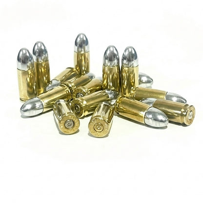 A jumbled pile of brass 9mm dummy casings with silver bullets, some showing spent-primers.