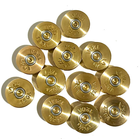 Twelve polished brass 12 gauge shotgun shell bottoms with Browning deer logo headstamps arranged in a cluster
